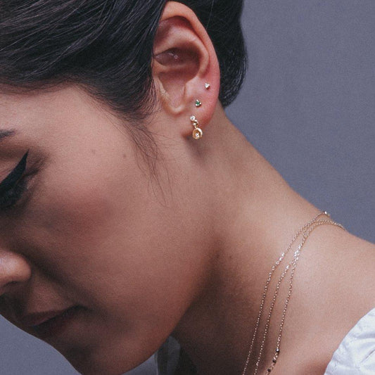 2mm Emerald Dot Stud (Single) by Jennie Kwon on a white background