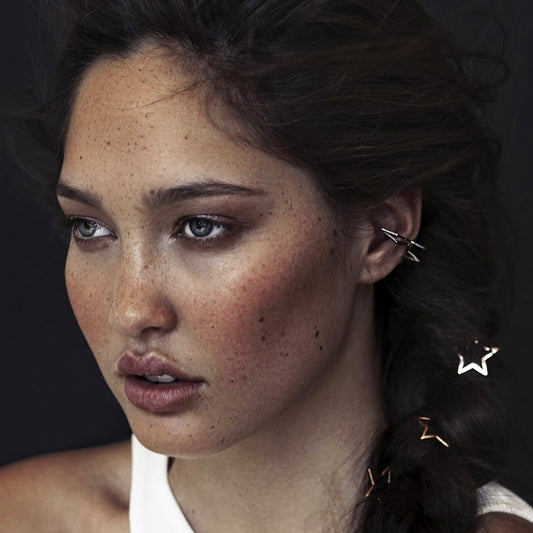 A silver star-shaped ear cuff.