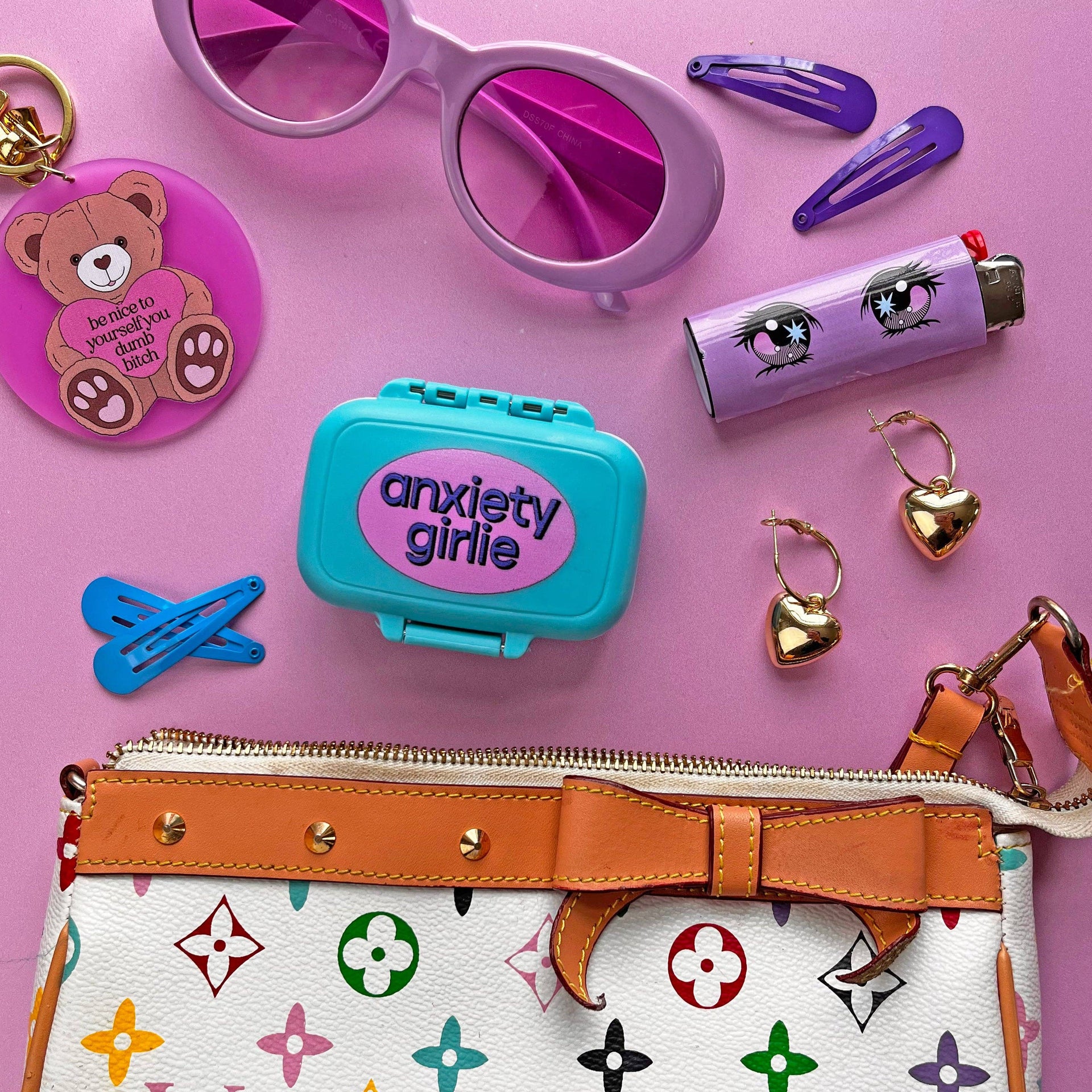 Collection of accessories including sunglasses, hair clips, and a handbag on a pink background