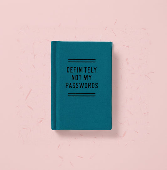 Teal notebook with 'DEFINITELY NOT MY PASSWORDS' text on a white background