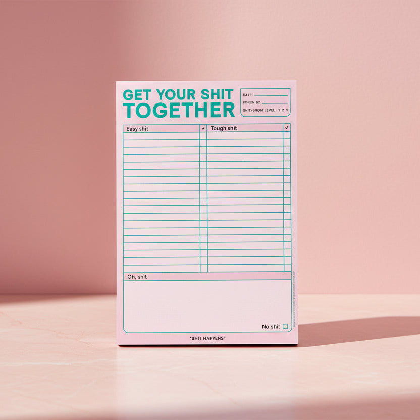 Notepad with text 'Get your shit together' on a pink background