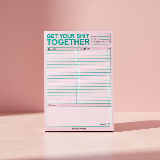 Notepad with text 'Get your shit together' on a pink background