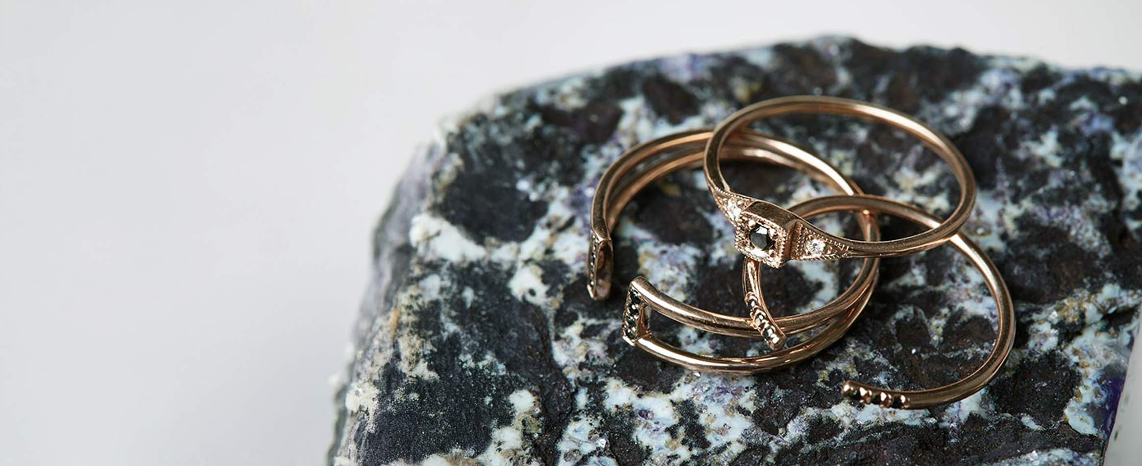 Jennie Kwon Black Diamond Mercato Ring on a plain table top with strong shadows