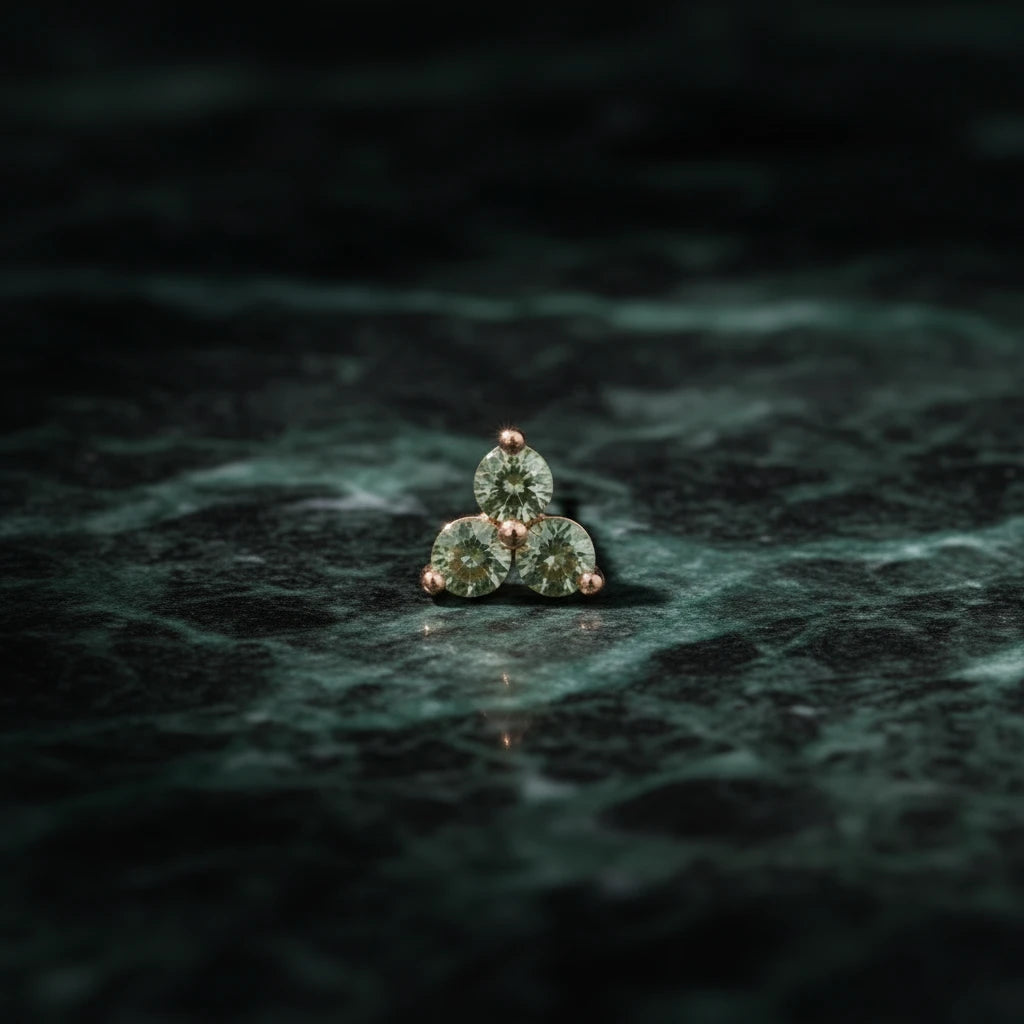 Jennie Kwon Green Sapphire Cluster Stud on green marble table top