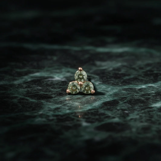 Jennie Kwon Green Sapphire Cluster Stud on green marble table top