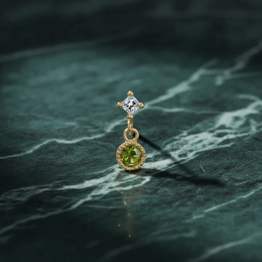 Jennie Kwon Green Sapphire PC Dangle Earring on blue marble