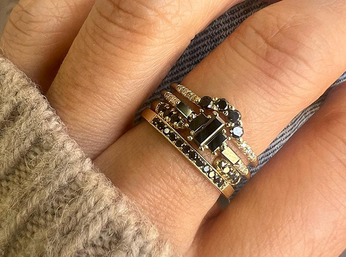 Black diamond Jennie Kwon ring stack on model's hand