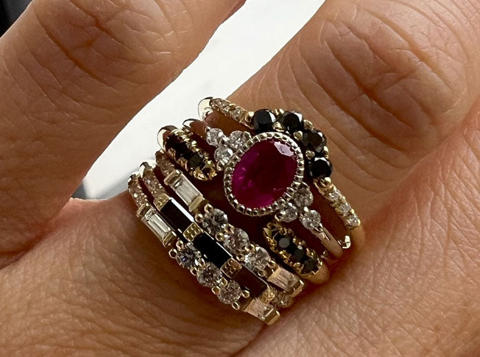Black diamond rings by Jennie Kwon, stacked with a ruby sapphire ring