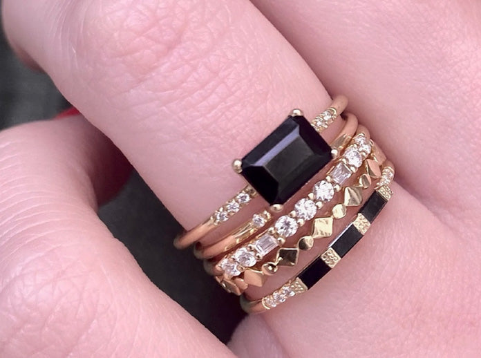Black diamond Jennie Kwon rings stacked on model's hand