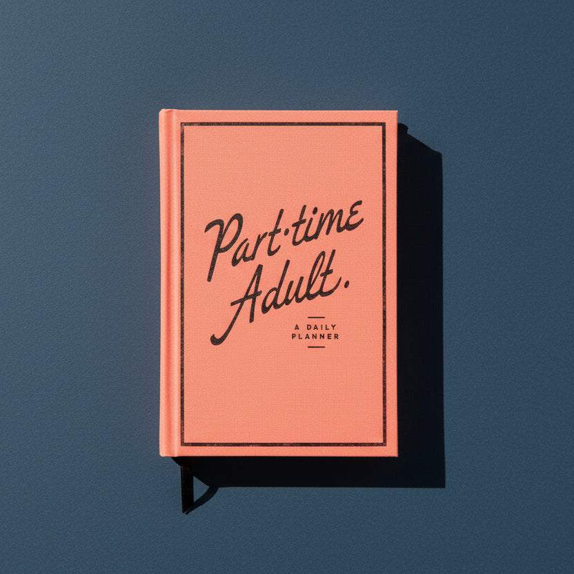 Coral planner with 'Part-time Adult' text on a dark blue background