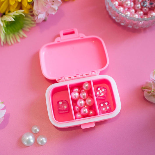 Pink container with a horse design on a pink background with flowers and pearls