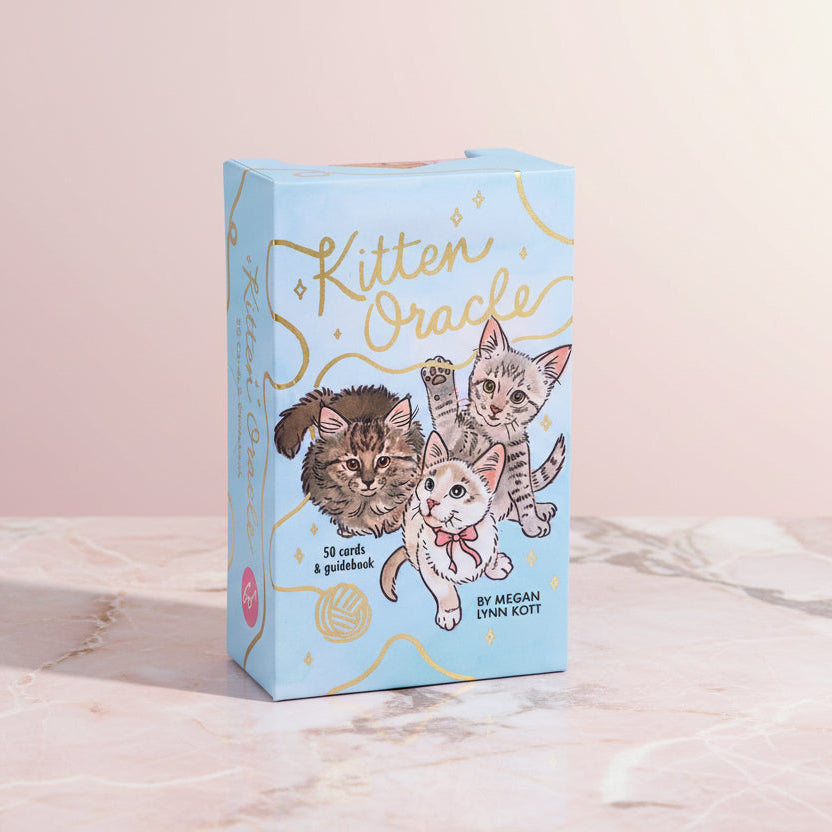 Kitten Oracle card set packaging with illustrations of kittens on a light pink background
